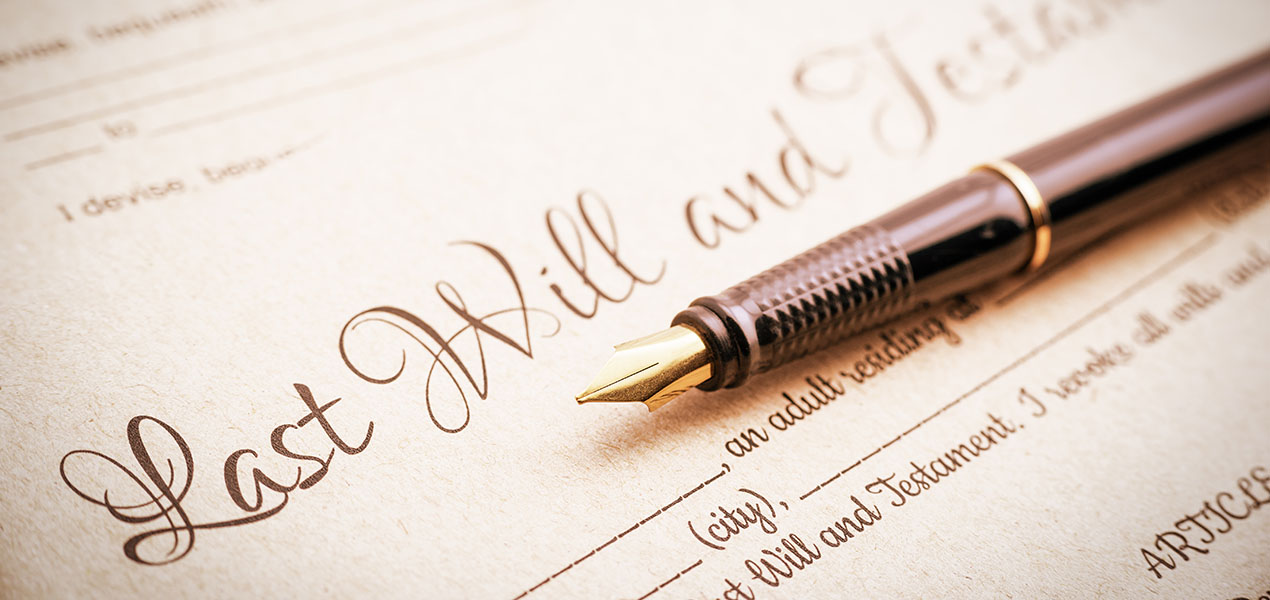A fountain pen on top of papers titled "Last will and Testament".
