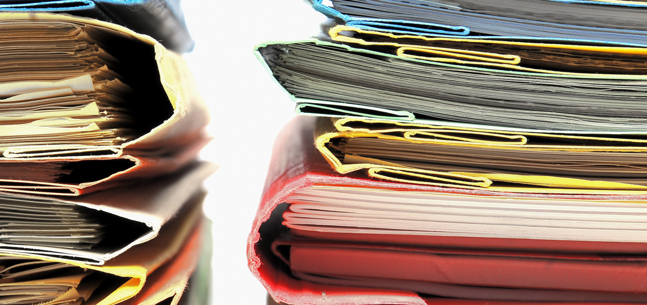 Two stacks of colourful file folders.